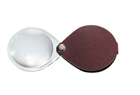 Circular magnifier inside clear oval setting, with attached fold-out burgundy case