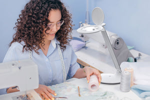 Woman using Halo-Go for sewing