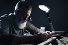 Load image into Gallery viewer, Man using Daylight&#39;s Foldi Go to examine a ring in a workshop.
